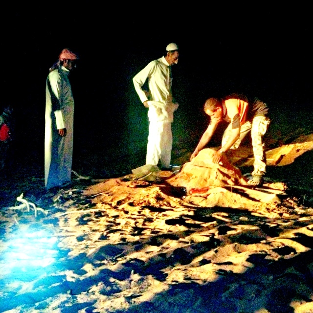 bedouins unearthing the zarb in wadi rum. 